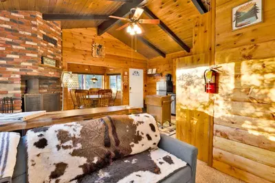 a living room with a couch and a ceiling fan at Orchard Family Cabin #2560 in Big Bear Lake