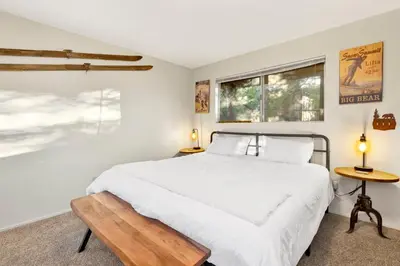 a bedroom with a white bed and a window at Orchard Family Cabin #2560 in Big Bear Lake