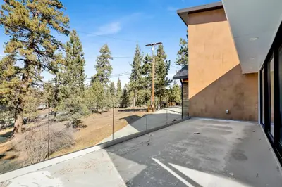 a house with a large glass window looking out at a field at Hillside Hideaway #603 in Big Bear Lake