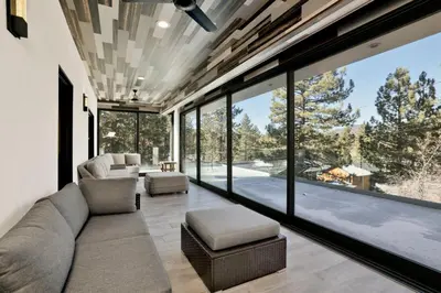 a living room with a large glass wall at Hillside Hideaway #603 in Big Bear Lake