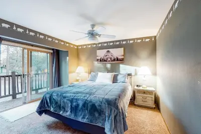 a bedroom with a bed and a large window at Rosie's Hideaway #331 in Big Bear Lake