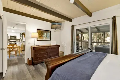 a bedroom with a bed and a balcony at Moose-in' Around in Big Bear Lake
