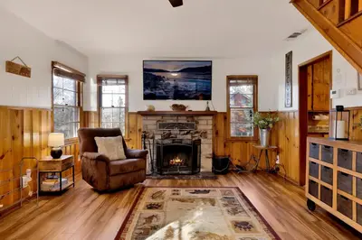 a living room with a chair and a fireplace at Quiet Cabin #564 in Big Bear Lake