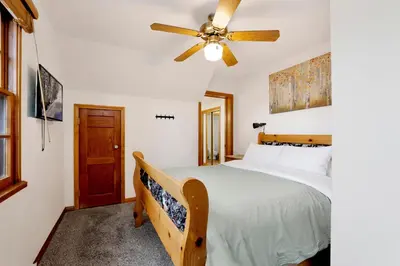 a bedroom with a bed and a ceiling fan at Quiet Cabin #564 in Big Bear Lake