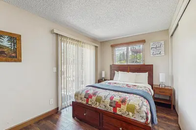 a bedroom with a bed and a window at Meadow-Front Metcalf Bay Gem #542 in Big Bear Lake
