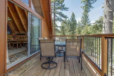 a screened porch with a table and chairs on a deck at Castle Rock Cabin #2 in Big Bear Lake