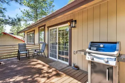a patio with a grill and chairs on a house at The Fox Den #2568 in Big Bear City
