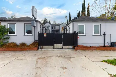 a black gate in front of a white house at Cozy Studio Studio City Unit 6 in Los Angeles
