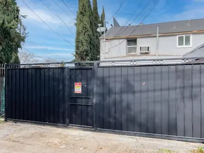 a black fence in front of a house at Cozy Studio Studio City Unit 6 in Los Angeles