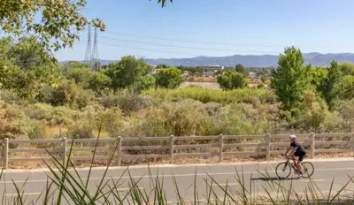 a man riding a bike down a road at Magic Splash Getaway in Santa Clarita