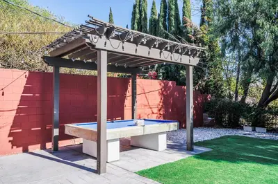 a picnic table under a pergola in a yard at Swinton in North Hills
