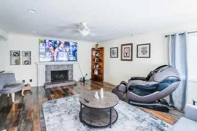 a living room with a chair and a fireplace at Swinton in North Hills