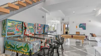 a room with a bunch of pinball machines at Luxe 8000 sqft w 2 Pools Sauna Putting Green Game Room Alta Vista Estate in Los Angeles