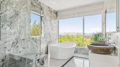 a bathroom with a tub and a sink and a window at Luxe 8000 sqft w 2 Pools Sauna Putting Green Game Room Alta Vista Estate in Los Angeles