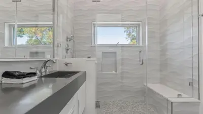 a white bathroom with a shower and a sink at Luxe 8000 sqft w 2 Pools Sauna Putting Green Game Room Alta Vista Estate in Los Angeles