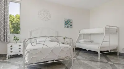 a bedroom with two bunk beds and a ladder at Luxe 8000 sqft w 2 Pools Sauna Putting Green Game Room Alta Vista Estate in Los Angeles