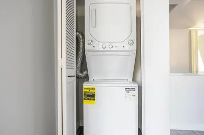 a washer and dryer sitting on top of a refrigerator at Blueground Sawtelle view nr Westwood Park LAX-1396 in Los Angeles