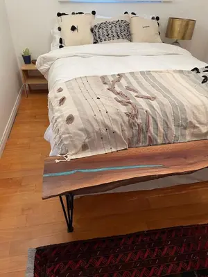 a bedroom with a bed with a wooden bench at Cozy Beach Bungalow- Happynest in Long Beach