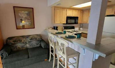 a kitchen with a counter top and a kitchen with a couch at Getaways at Lagonita Lodge in Big Bear Lake