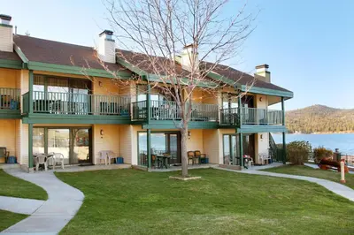a house with balconies and a lake at Getaways at Lagonita Lodge in Big Bear Lake