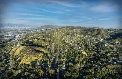 an aerial view of a city on a mountain at Chic Private Hollywood Hills Guest Suite Oasis with Tree-Top Views, Outdoor Living Room, Only 2 Minutes from Hollywood Boulevard in Los Angeles