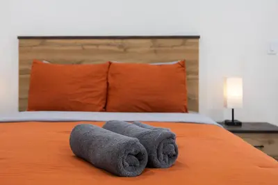 a bed with two towels on top of it at Sunset Chateau Hollywood in Los Angeles