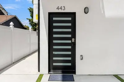 a black door on the side of a house at Sunset Chateau Hollywood in Los Angeles