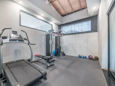 a gym with a treadmill and a chair in a room at Sycamore Villa in Los Angeles