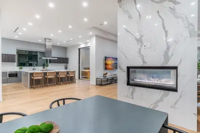 a kitchen and a living room with a large fireplace at Laurel K Villa in Los Angeles