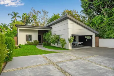 a small white house with a patio in a yard at Fulton Villa in Garnsey