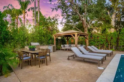 a patio with a gazebo and a table and chairs at Fulton Villa in Garnsey