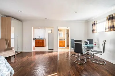 a living room with a table and chairs and a kitchen at King Studio with Self Check-In in Ontario