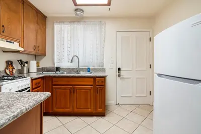 a kitchen with a sink and a white refrigerator at King Studio with Self Check-In in Ontario