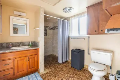 a bathroom with a toilet and a sink and a shower at King Studio with Self Check-In in Ontario