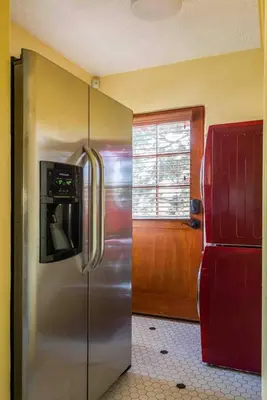 a kitchen with a stainless steel refrigerator with a microwave at Welcome to The Spanish Hideaway! in Los Angeles