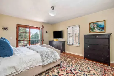a bedroom with a bed and a dresser and a television at Welcome to The Spanish Hideaway! in Los Angeles