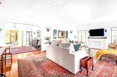 a living room with a couch and a tv at Welcome to The Spanish Hideaway! in Los Angeles