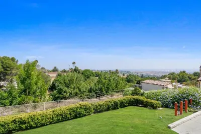 a garden with a fence and a lawn with trees at City View Rancho Palos Verdes Home in Rancho Palos Verdes