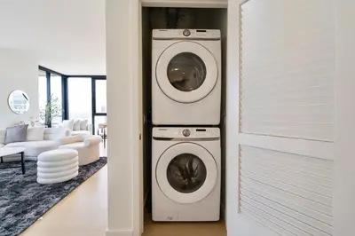 a washer and dryer in a living room at Sky High at Beaudry 2 Bed Apt WITH FREE PARKING in Los Angeles