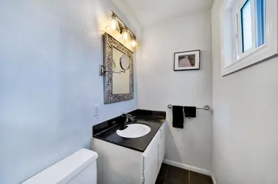 a white bathroom with a sink and a mirror at Awesome On The Strand, Hermosa Beach Property in Hermosa Beach