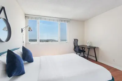 a bedroom with a white bed and a window at Top Floor Marina Escape 3BR Penthouse Ocean View in Los Angeles