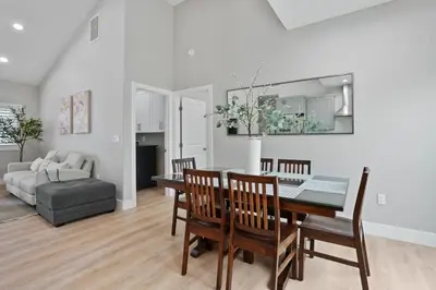a dining room and living room with a table and chairs at 2 Mi to Disneyland Home with Furnished Patio! in Anaheim