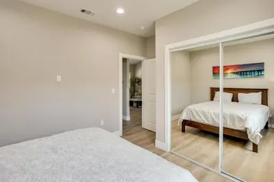 a bedroom with a bed and a mirror at 2 Mi to Disneyland Home with Furnished Patio! in Anaheim