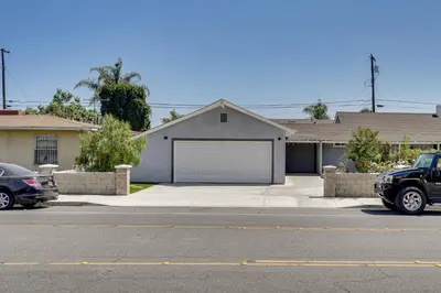a car parked in front of a house with a garage at 2 Mi to Disneyland Home with Furnished Patio! in Anaheim