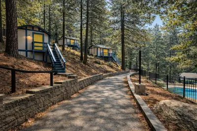 a path leading up to a house in the woods at Arrowhead Ranch Retreat and Conference Center in Lake Arrowhead