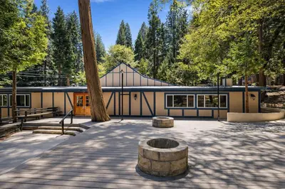 a building in a park with a tree at Arrowhead Ranch Retreat and Conference Center in Lake Arrowhead