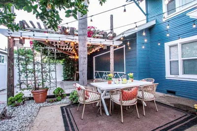 a patio with a table and chairs under a pergola at All New Apt Mins Beach, Downtown & Convention Ctr LB ADU in Long Beach