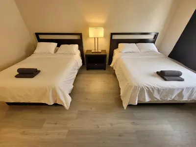two beds sitting next to each other in a room at Beverly Hills Nest in Los Angeles
