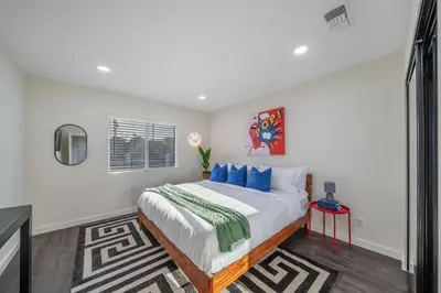 a bedroom with a large bed with blue pillows at Bellaire in Garnsey