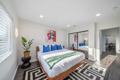 a bedroom with a large bed with blue pillows at Bellaire in Garnsey